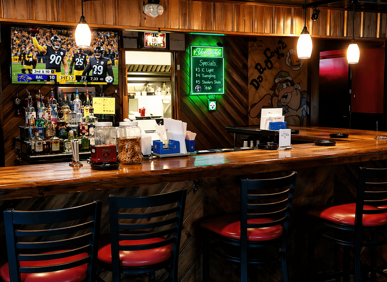 Inside BoRocks Bar and Grille with red stools, wood bar, beer signs, TVs, and the Da BoRocks mural